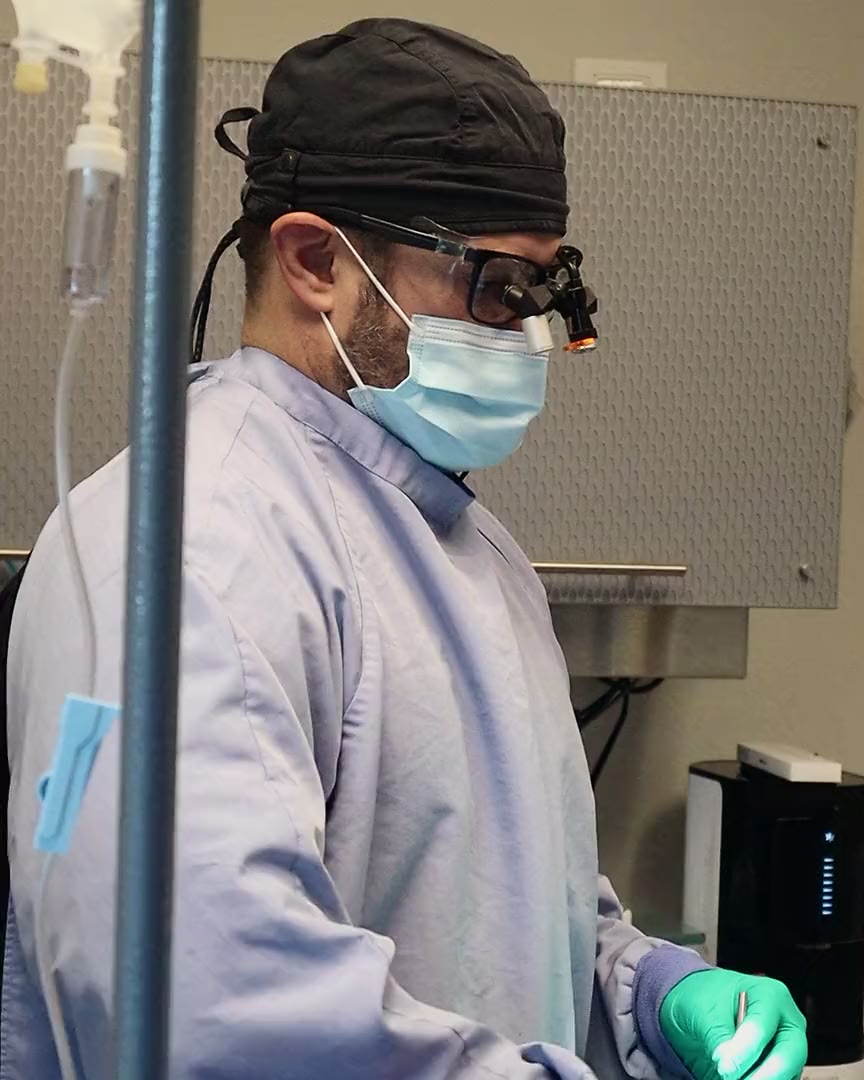 A doctor in surgical loupes working in the surgical suite at The Dental Studio of Midland