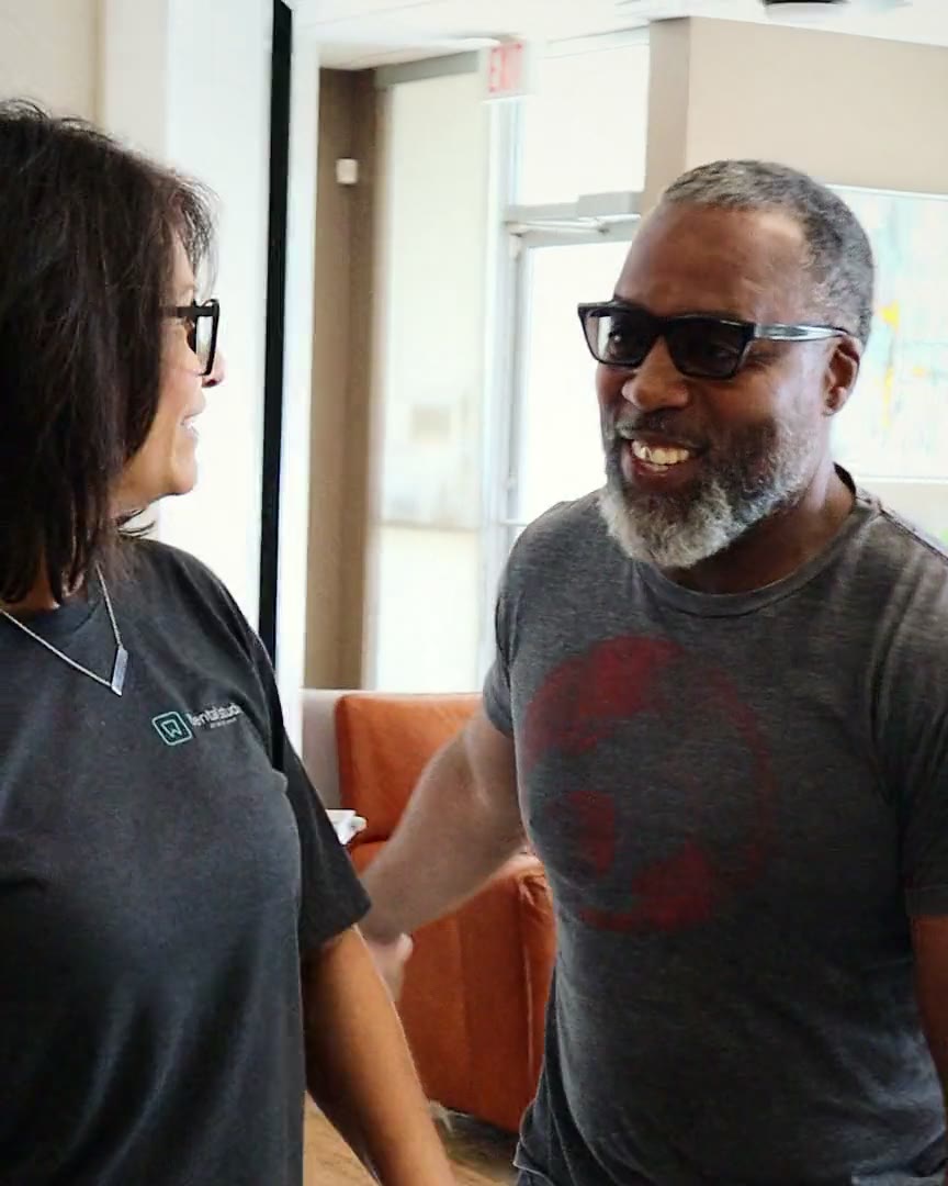A team member welcoming a patient in the reception area of The Dental Studio of Midland