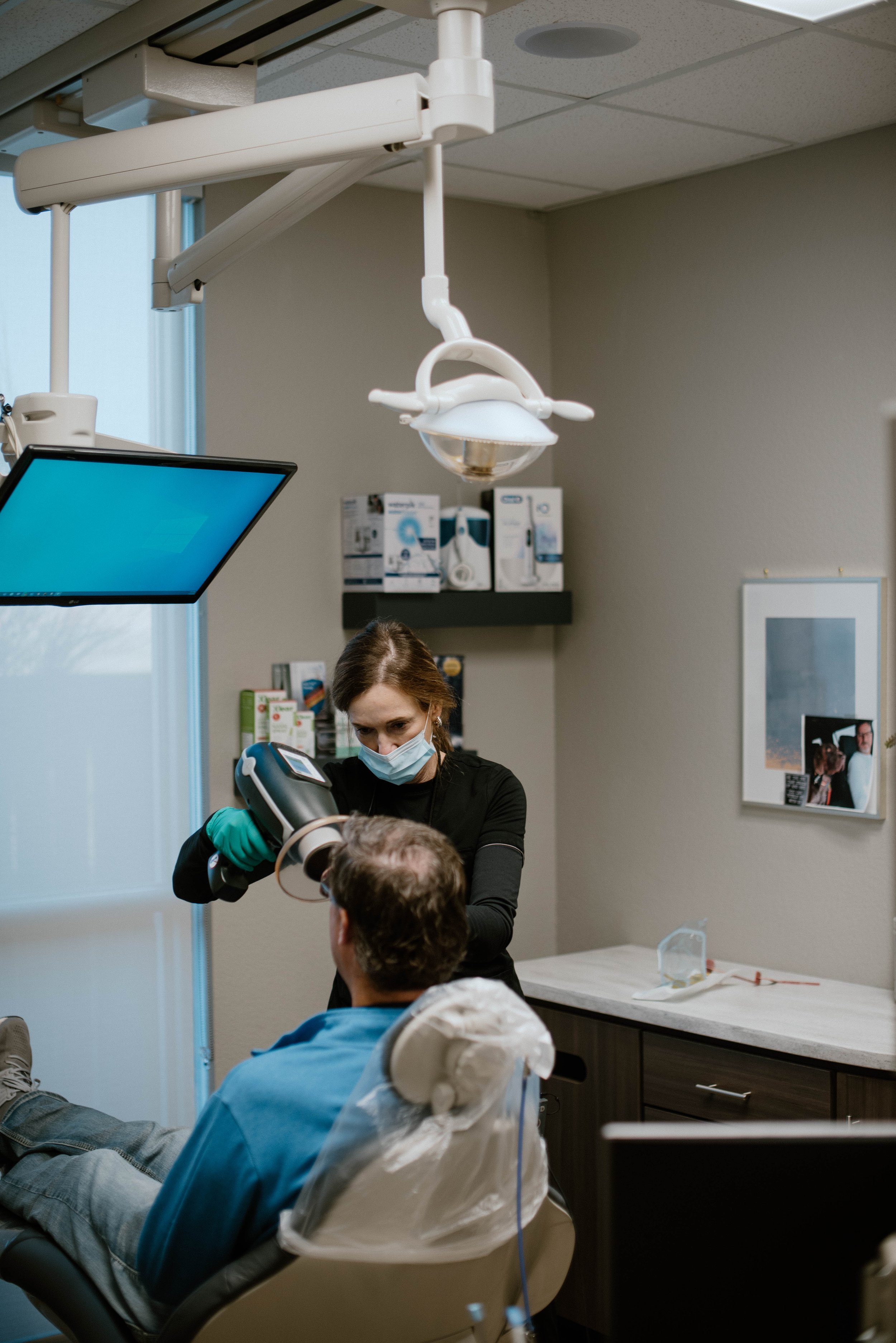 A patient receiving a checkup in a modern operatory at The Dental Studio of Midland