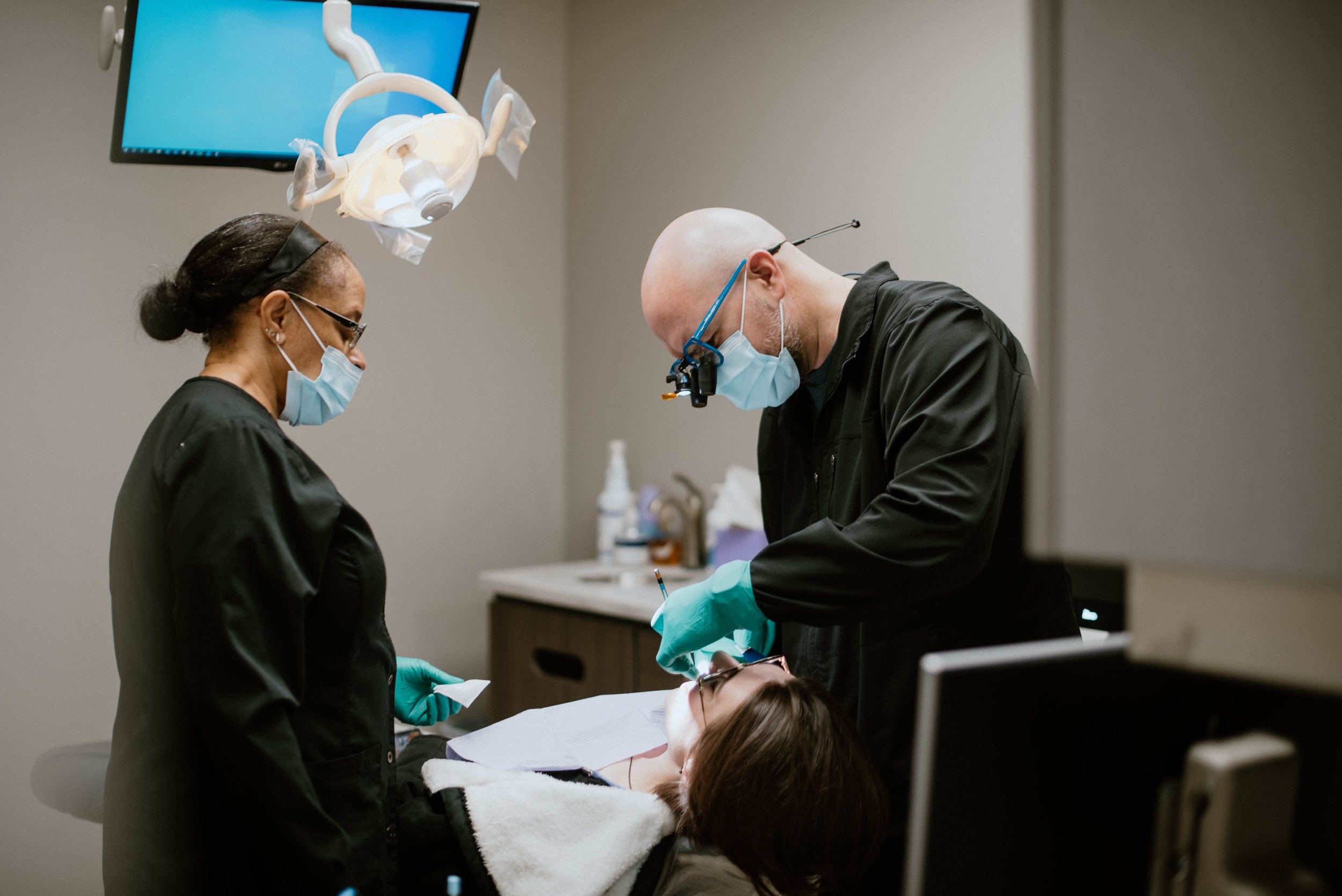 The surgical team caring for a relaxed patient during a sedation procedure